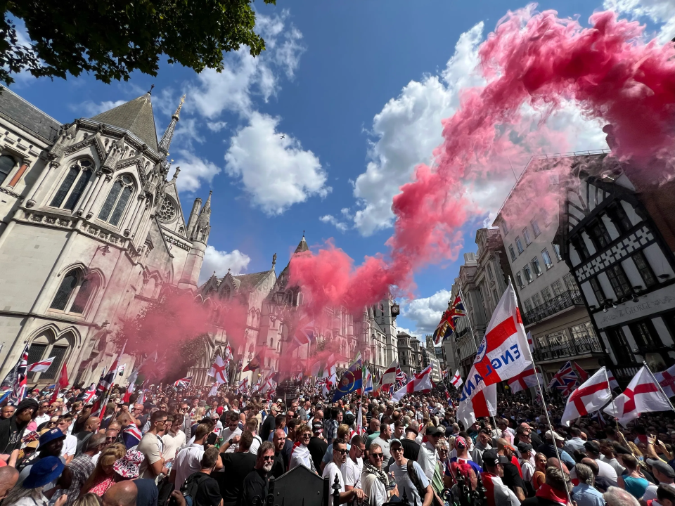 A flare is set off as demonstrators march during the event this weekend