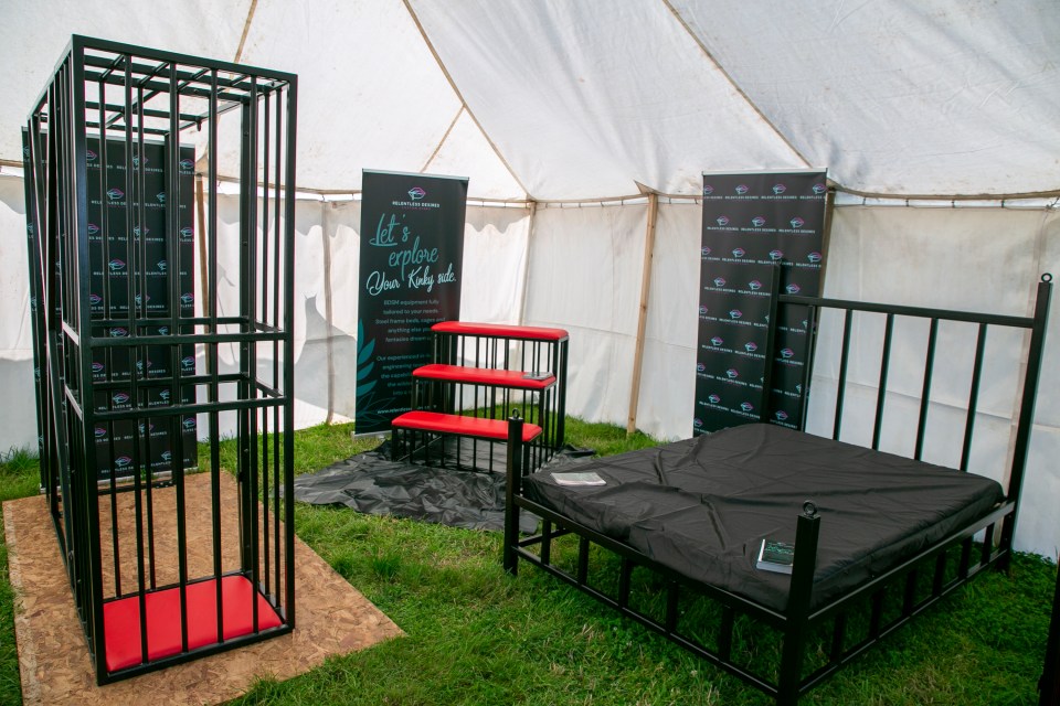 There's cages and kinky stands inside the BDSM and fetish tent