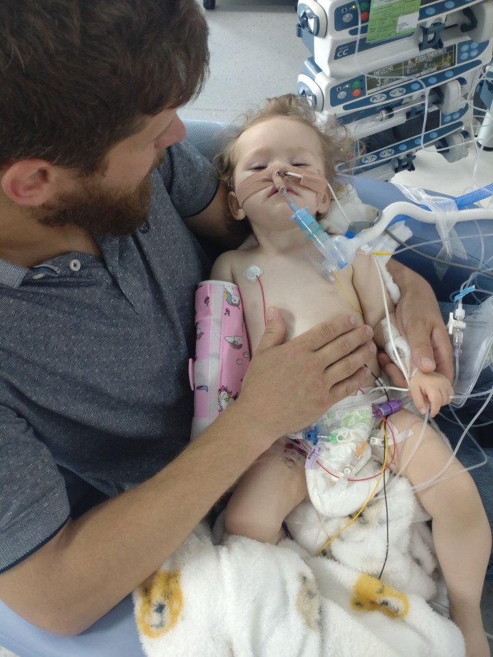 One-year-old Beatrix in hospital – she is pictured with dad, Luke, 36