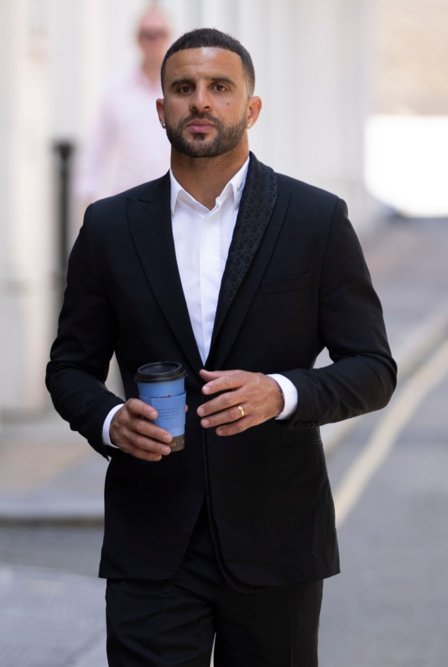 a man in a suit is holding a cup of coffee that says ' coffee ' on it