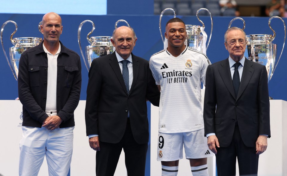 soccer player wearing a white emirates fly better jersey