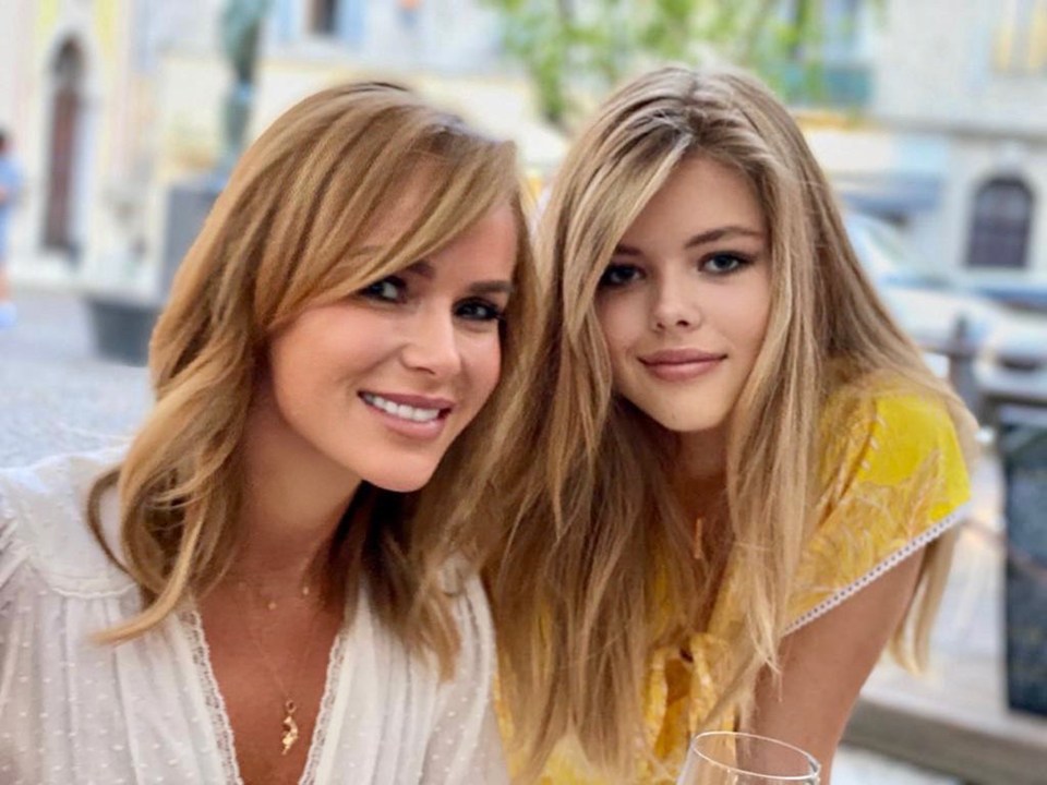 a woman and a girl are posing for a picture