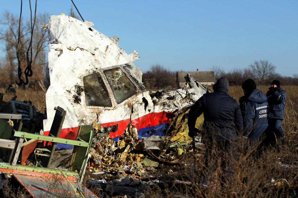 Local workers transport a piece of wreckage from Malaysia Airlines flight MH17 at the site of the plane crash near the village of Hrabove in Donetsk region, eastern Ukraine