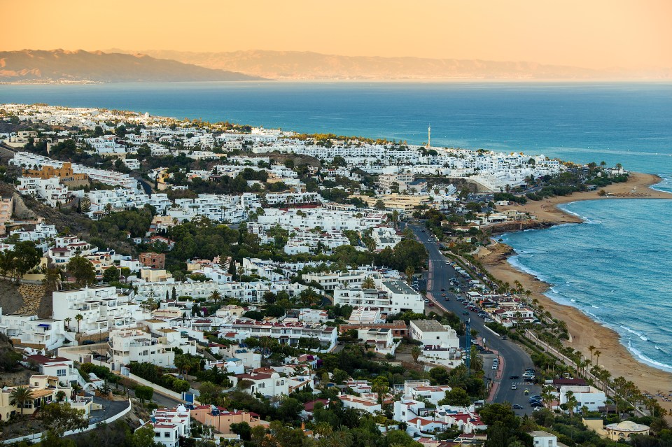 an aerial view of a city near the ocean