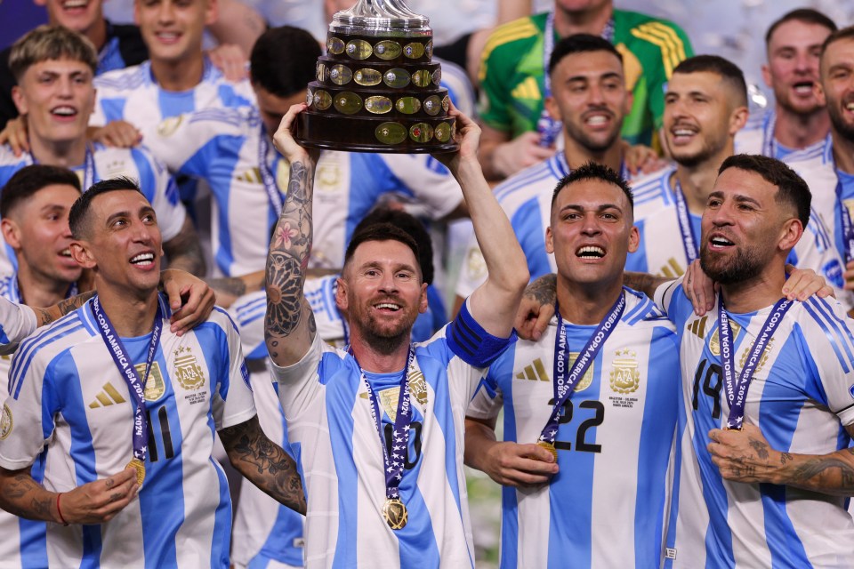 a soccer player with the number 22 on his jersey holds up a trophy