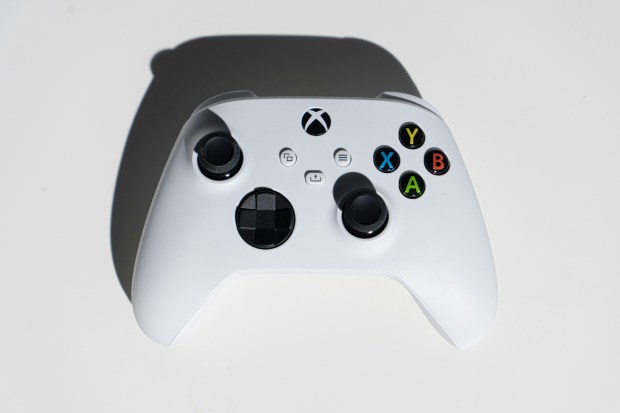 a white xbox controller with a shadow on it