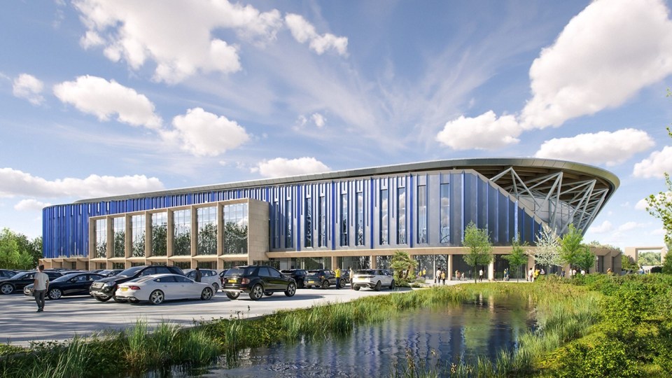 cars are parked in front of a large blue building