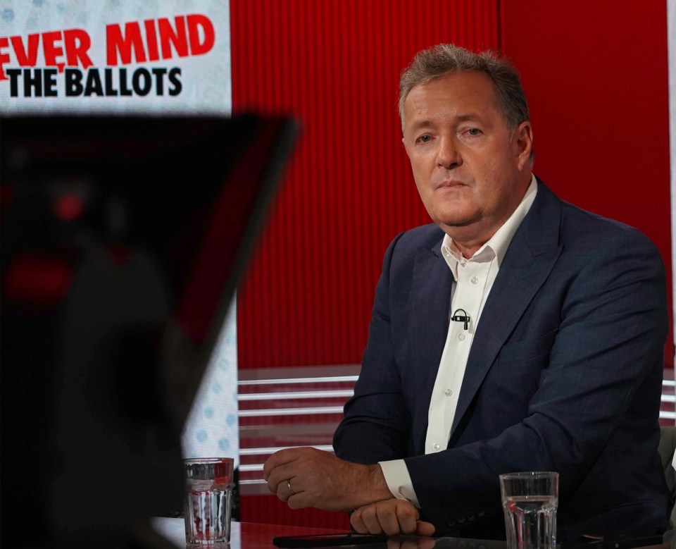 a man sits in front of a sign that says " ever mind the ballots "