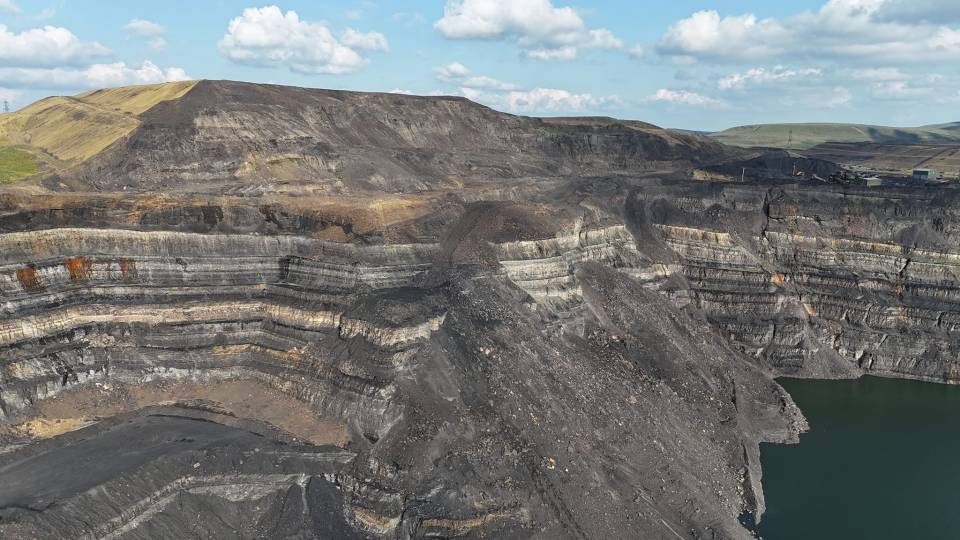 Drone images put into perspective the steepness of the site above the 'potentially deadly' lake below