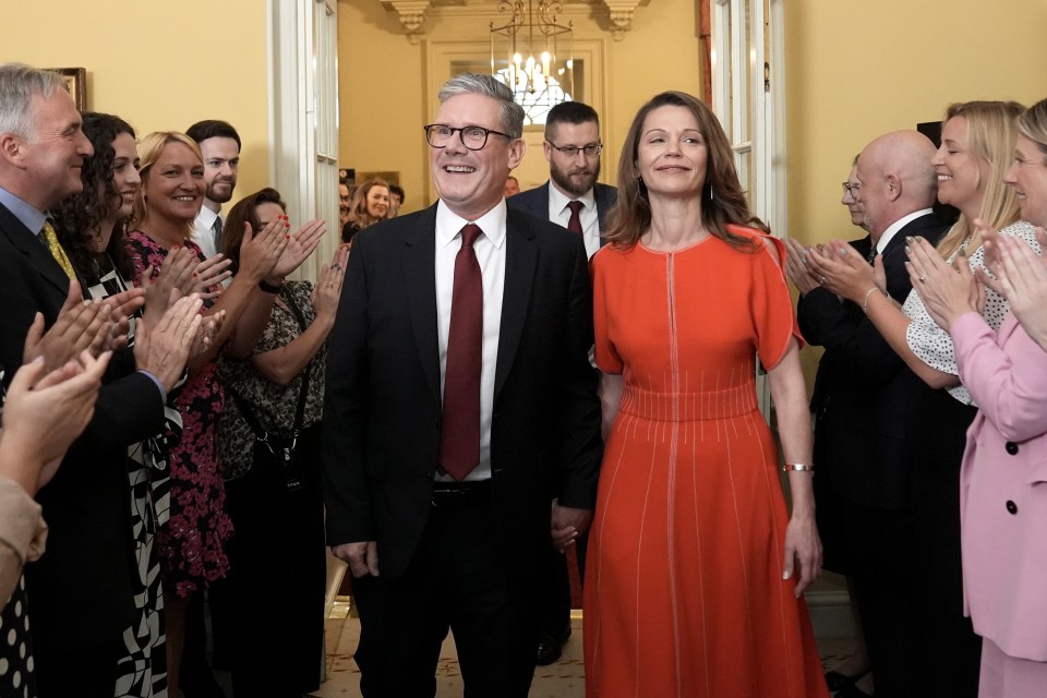 The pair were cheered on by staff as they walked through after the new PM made his first address to the nation