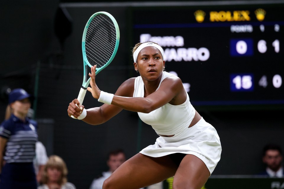 a woman holding a tennis racquet in front of a scoreboard that says rolex