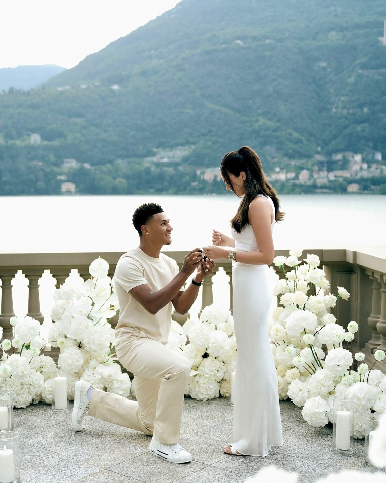 a man is kneeling down to propose to a woman