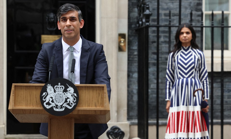 a man stands at a podium with a coat of arms on it