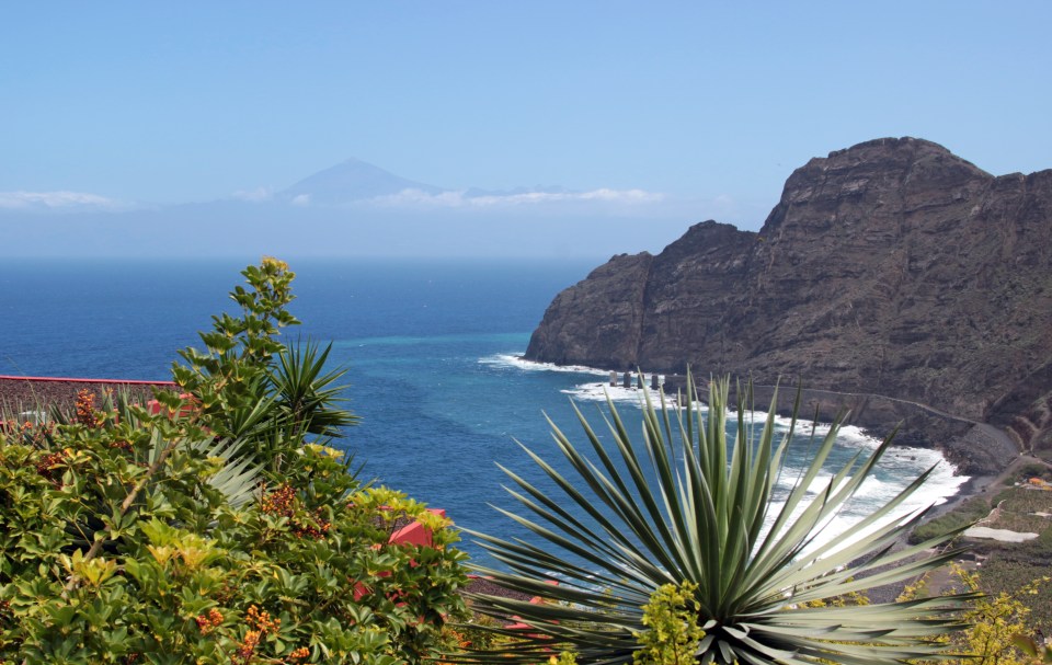 a view of the ocean with a mountain in the background