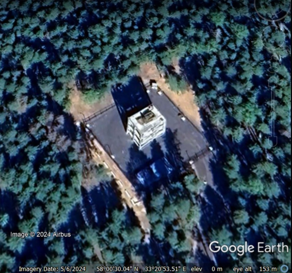 Another picture from May shows the large green military vehicle precisely positioned on top of the white structure