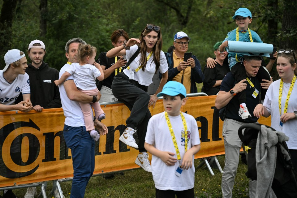 Cavendish's wife Peta Todd (centre) hurdles the barrier to celebrate his win