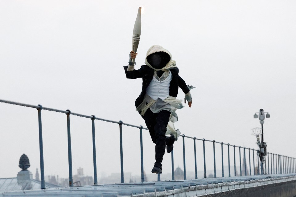 The Olympic mascot ran across rooftops before riding on a zip wire