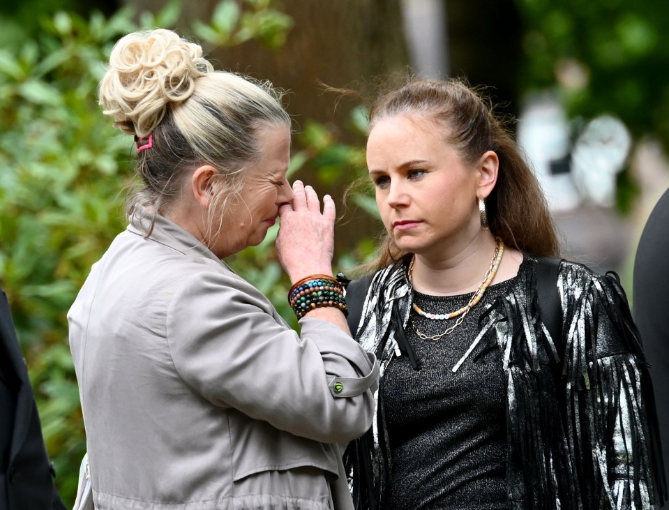 An emotional Bernie and Gemma support one another at the funeral service for Paul