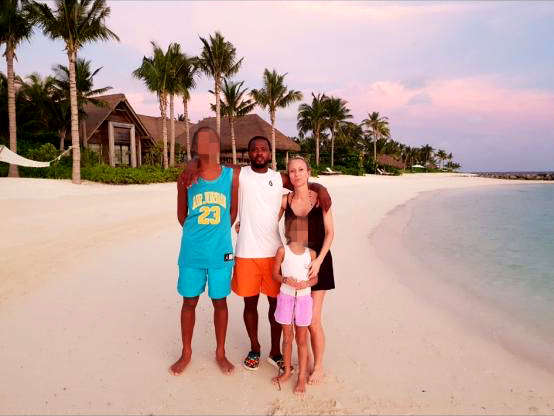 a group of people are posing for a picture on a beach .