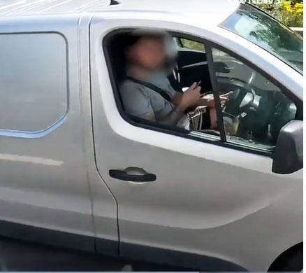 Police filmed a driver trimming his beard while doing 70mph on a packed motorway