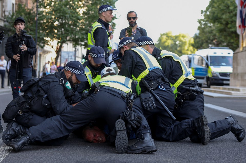 Cops detain a man amid the chaos