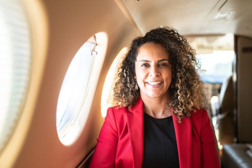 Wearing a red outfit will help you stand out and get your noticed on a plane, research suggests (stock image)