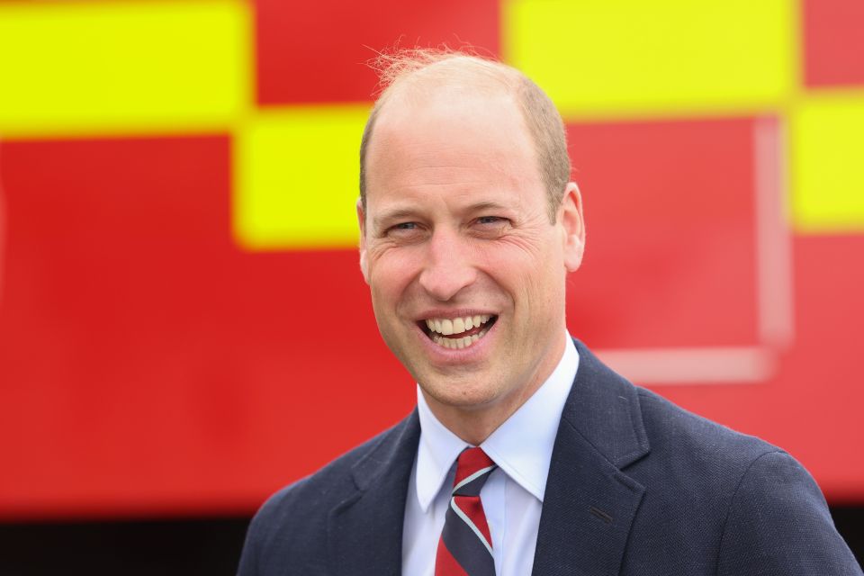 William is seen laughing at RAF Valley this afternoon