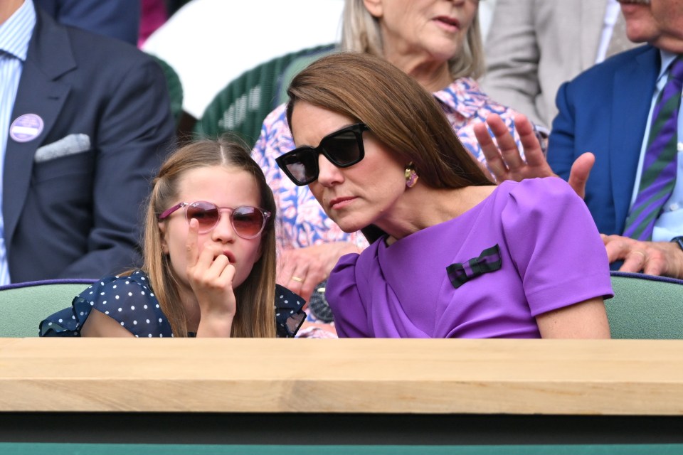 The mother-daughter duo looked tense as they donned sunglasses and watched on