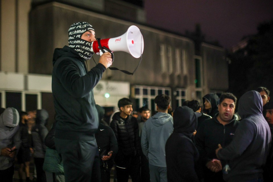 a man is holding a megaphone that says ' jvc ' on it