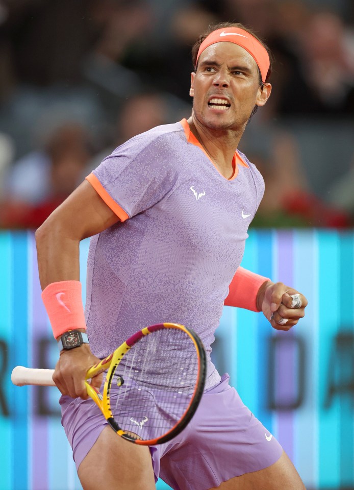 a man wearing a nike headband is holding a tennis racquet