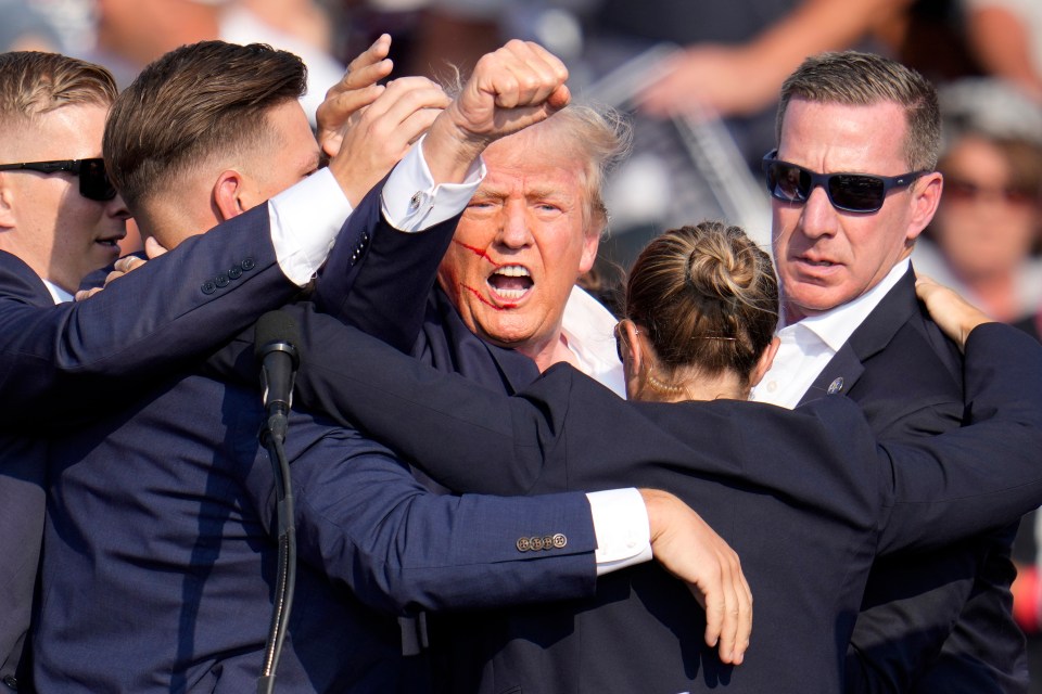 The former president raised his fist in the air in a sign of defiance after surviving the shooting