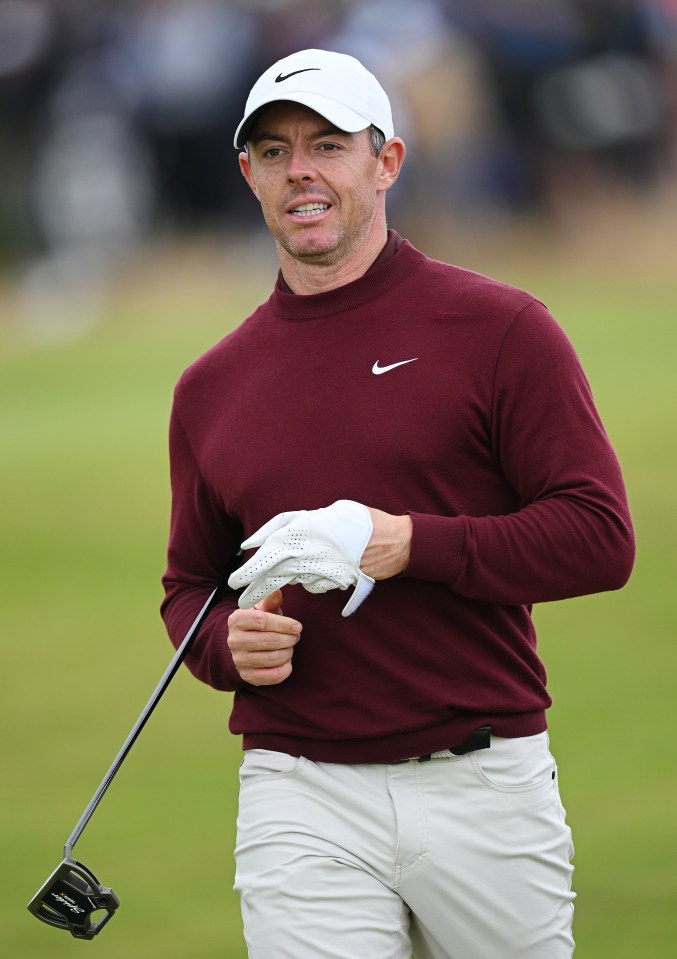 a man wearing a maroon nike shirt is holding a golf club