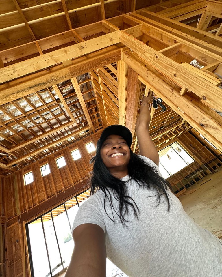 a woman taking a selfie in a house under construction