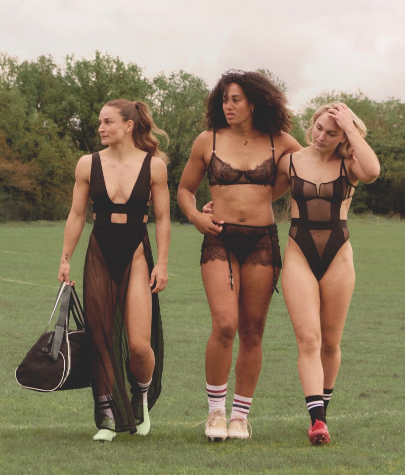 three women in lingerie are walking on a field