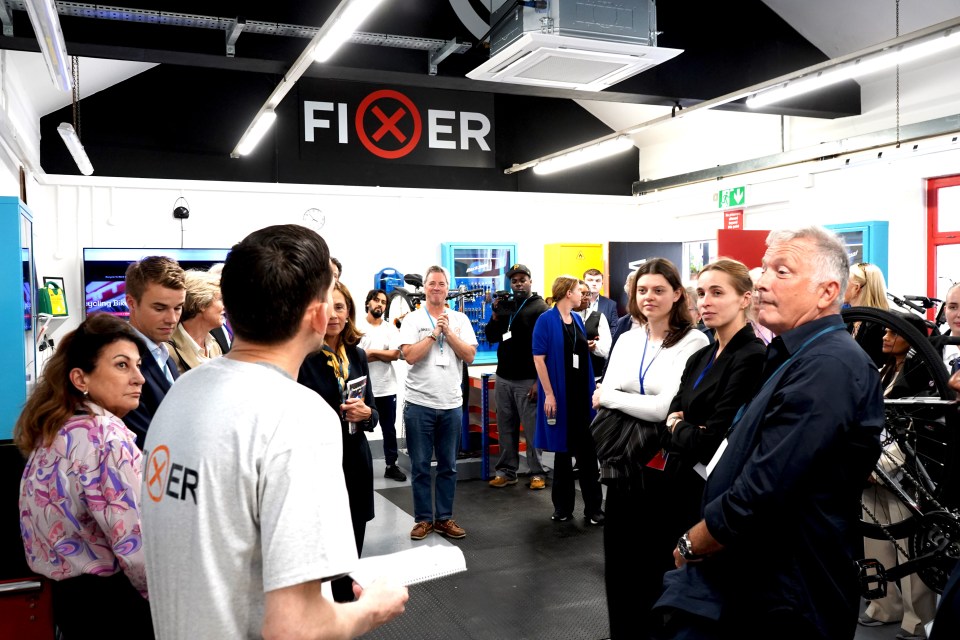 a group of people are gathered under a sign that says fixer