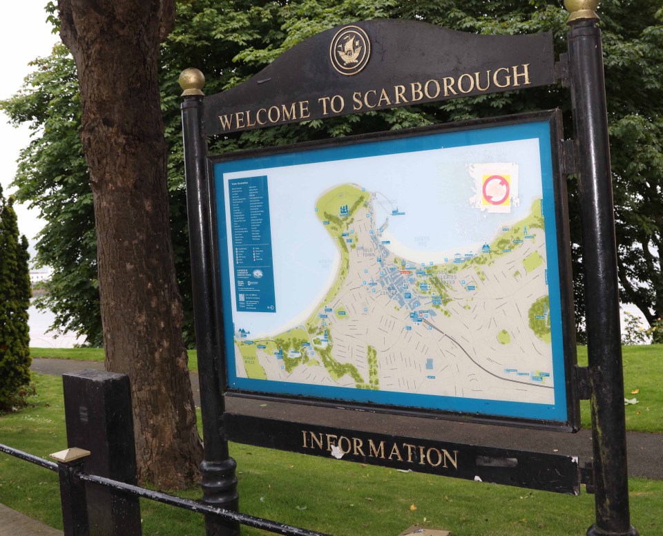 a welcome to scarborough sign with a map on it