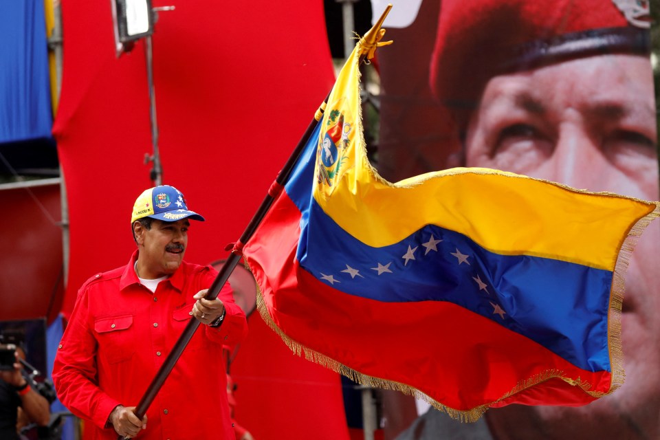 Maduro waves a flag during a rally to mark the anniversary of late Venezuelan President Hugo Chavez’s initial coup attempt in 1992