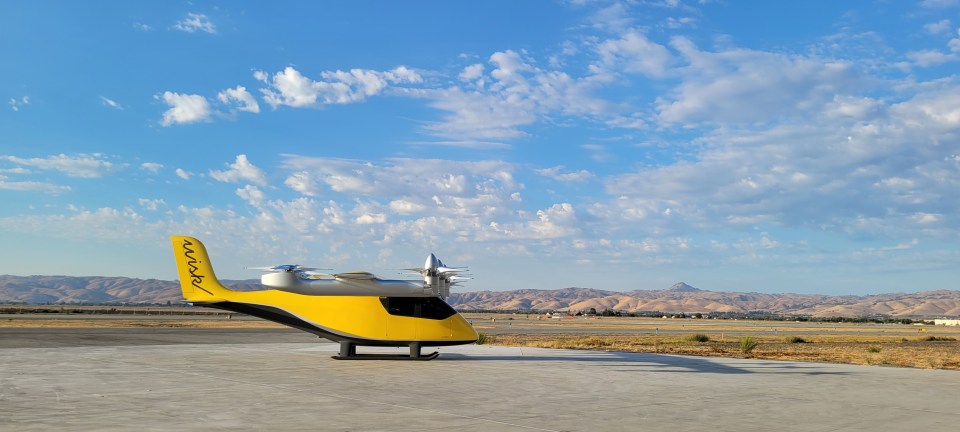 a yellow and black plane with the word mark on the tail