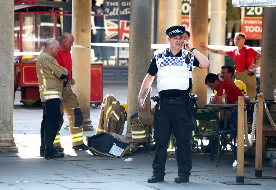 a police officer is talking on a cell phone