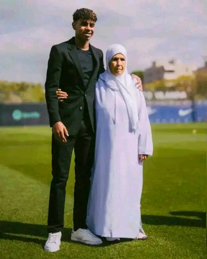 a man in a suit stands next to a woman in a white dress