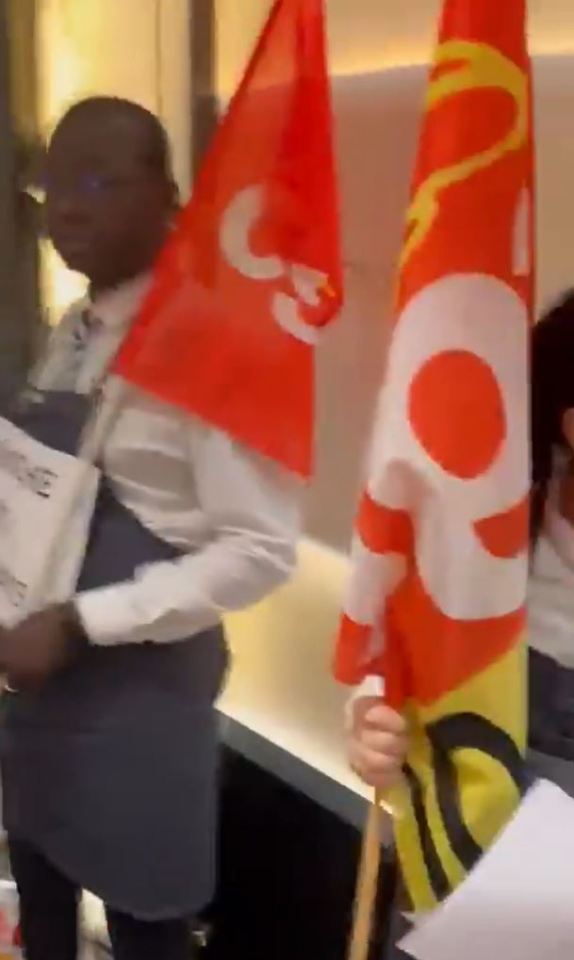 They held up flags as they made their stand against the hotel's owner