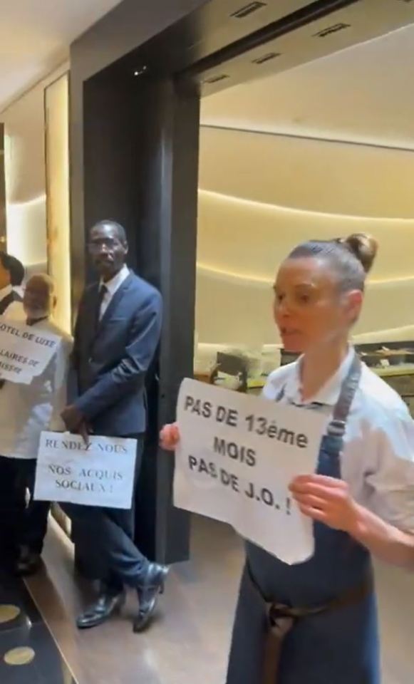 Various staff members held up banners with messages of protest