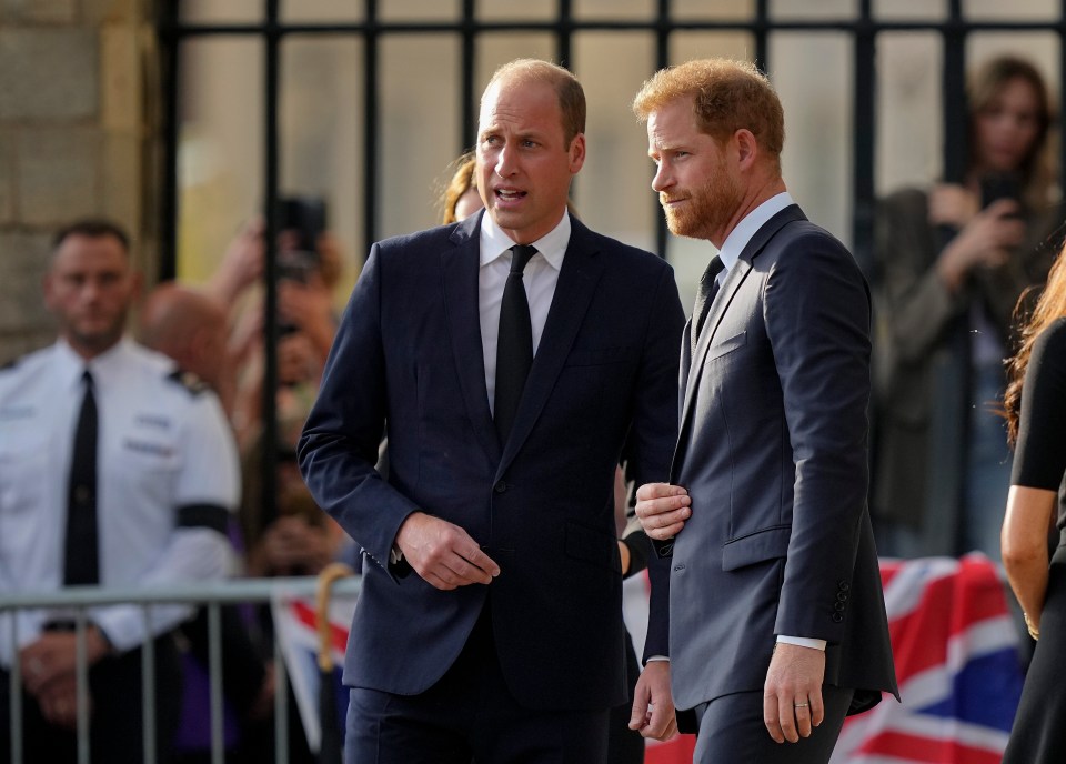 two men in suits are standing next to each other