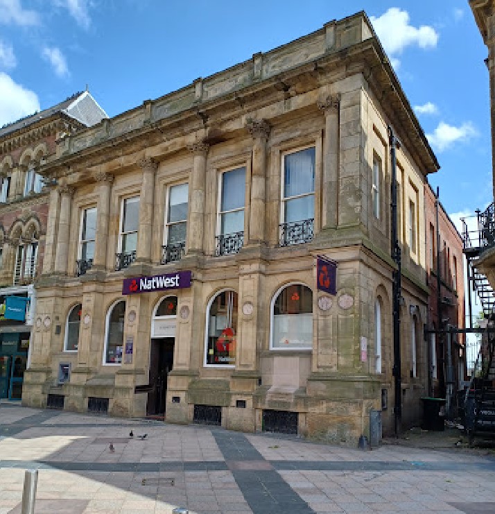 a building with a purple sign that says natwest