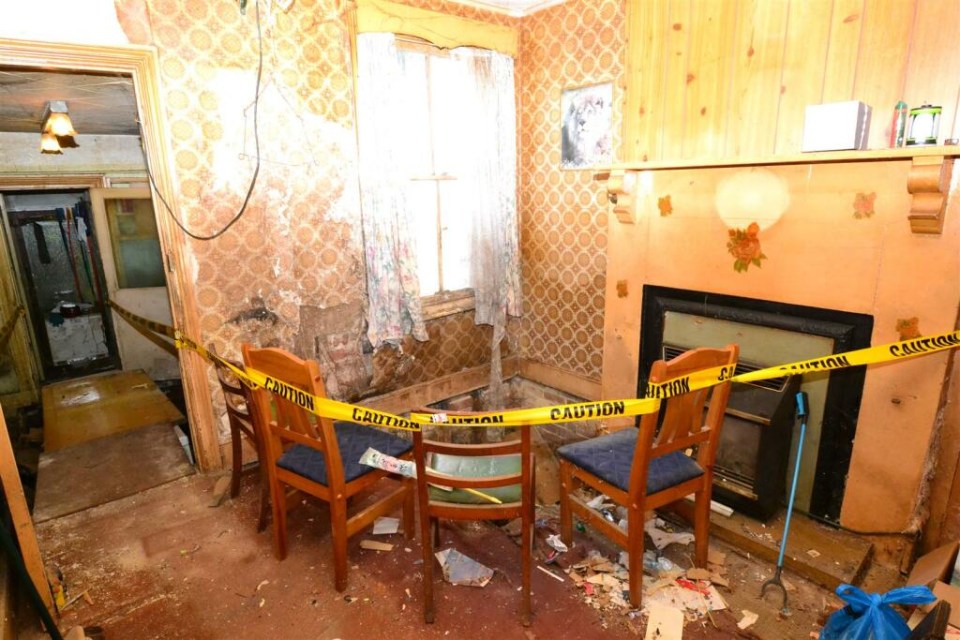 a room with a yellow caution tape around the chairs