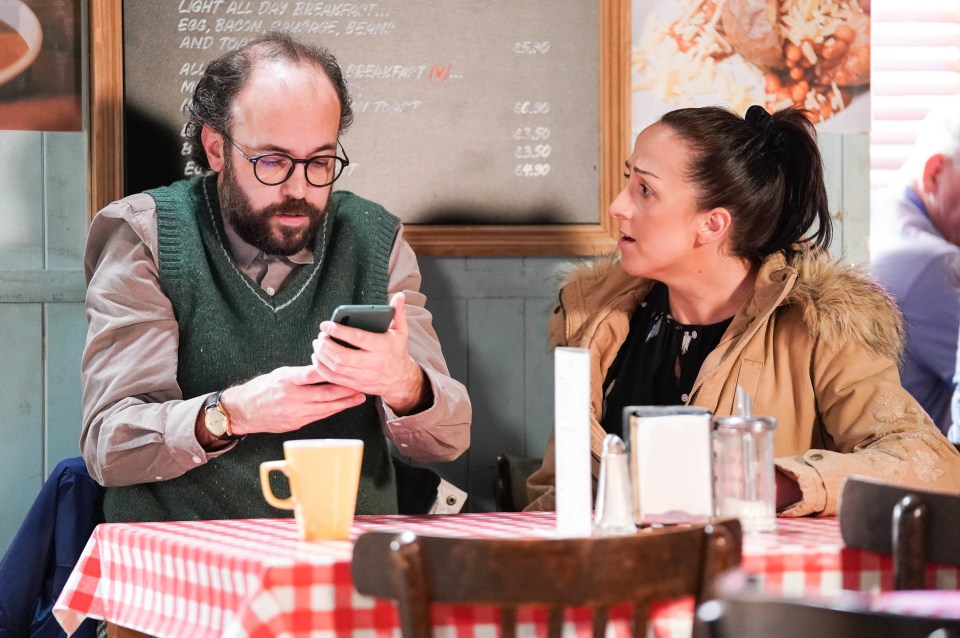 a man and a woman sit at a table in front of a menu that says light all day breakfast