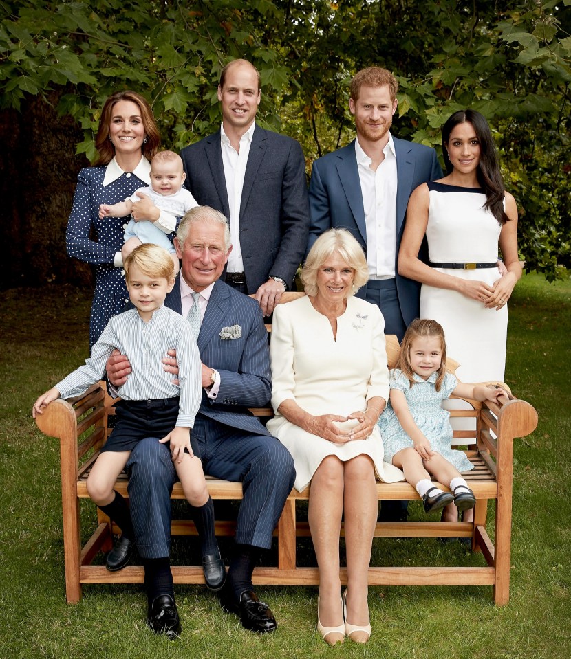 the royal family poses for a picture on a bench