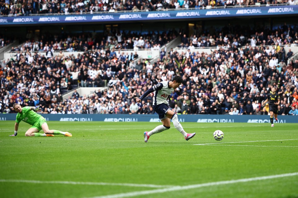 soccer player wearing a tottenham jersey kicking the ball