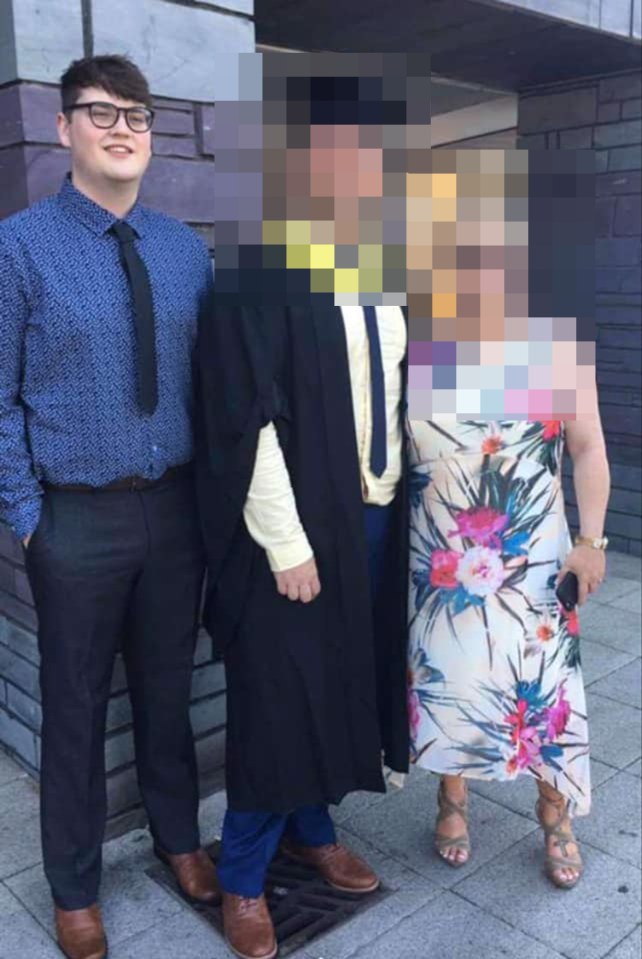 a man in a graduation cap and gown stands next to a woman in a floral dress