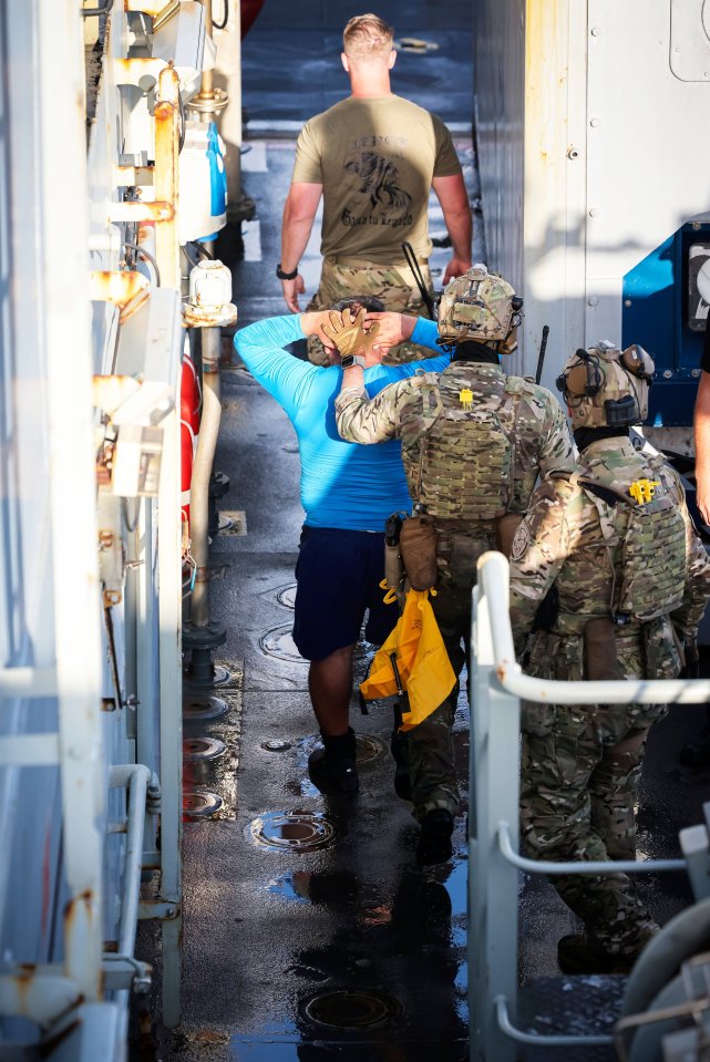 Royal marines could be seen escorting the alleged drug traffickers on board the ship